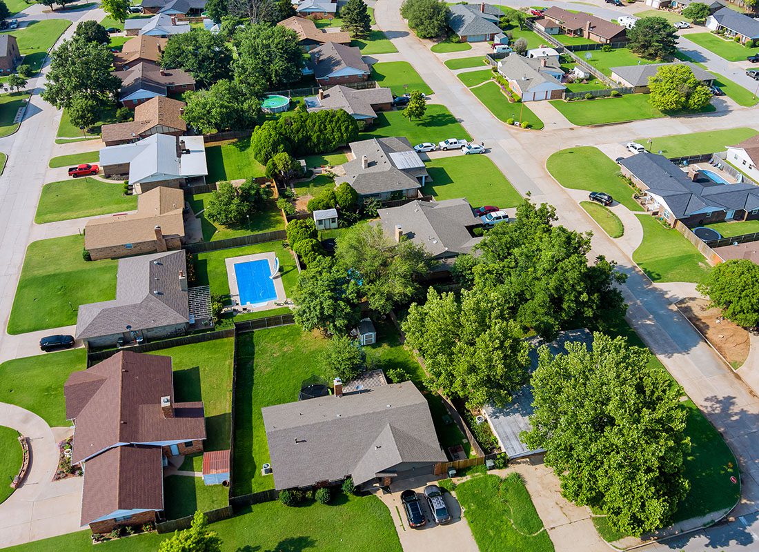 Choctaw, OK - Aerial View of Residential Homes With Trees in Oklahoma on a Sunny Day