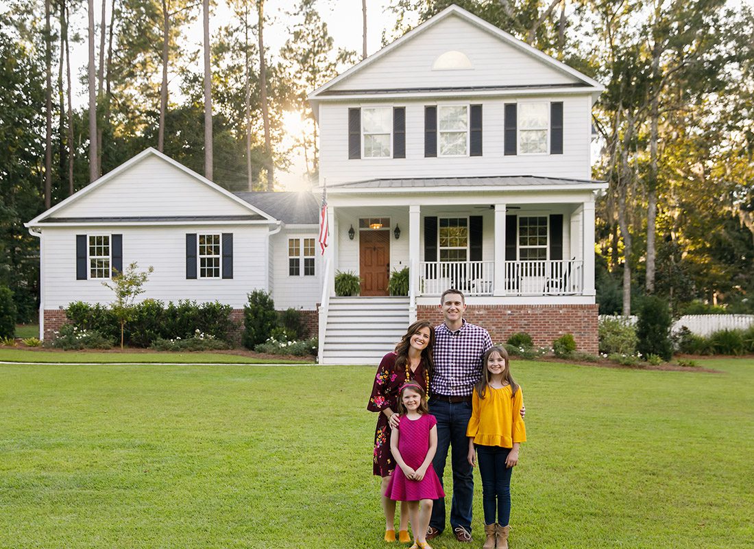 Personal Insurance - Family Standing in Front of Their Home