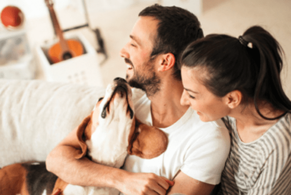 Nationwide's Pet Referral Program - Couple sitting on a couch with their dog
